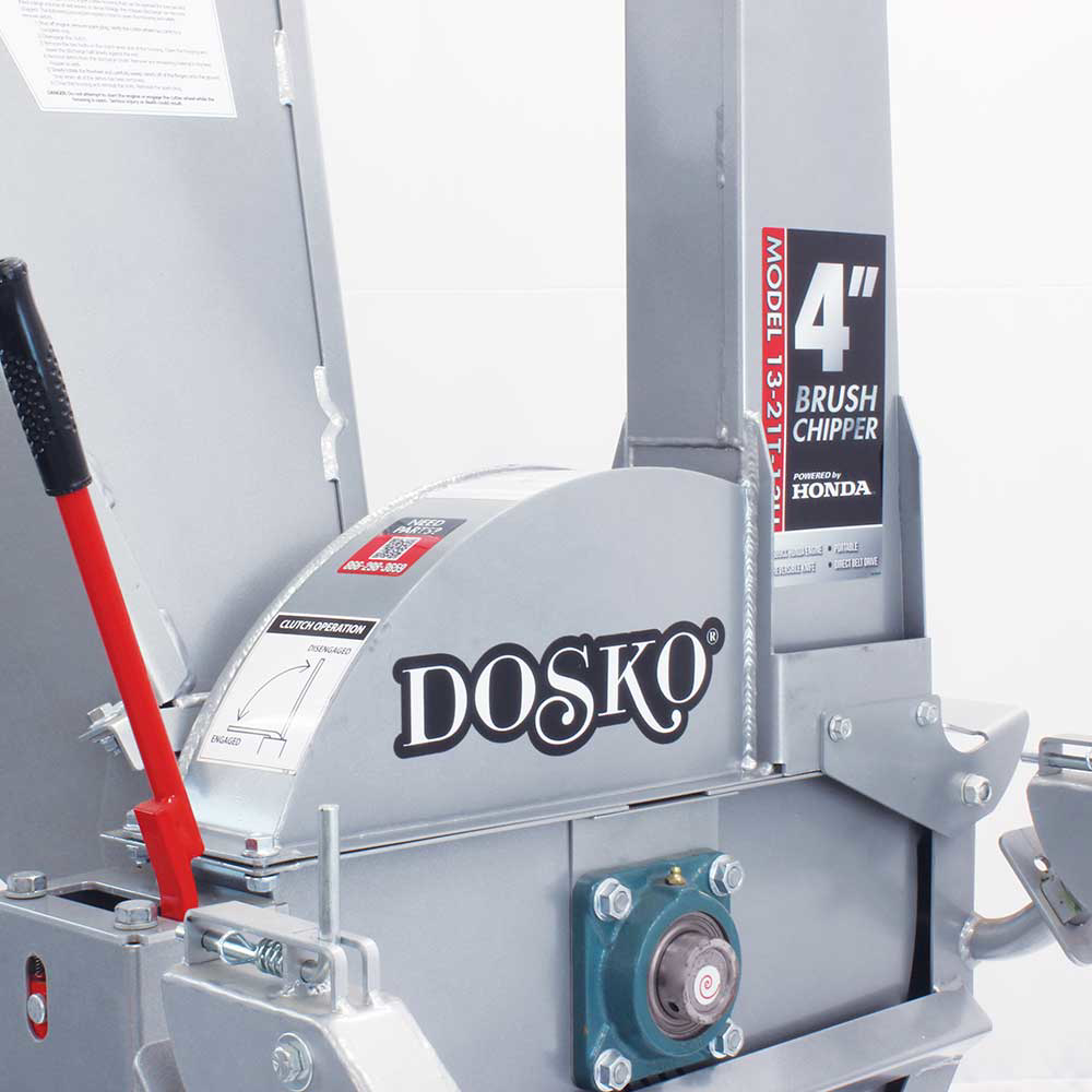 A close-up view of the Dosko 13-21T-13H brush chipper's body, highlighting the 'DOSKO' and '4" BRUSH CHIPPER' branding with a red handle.