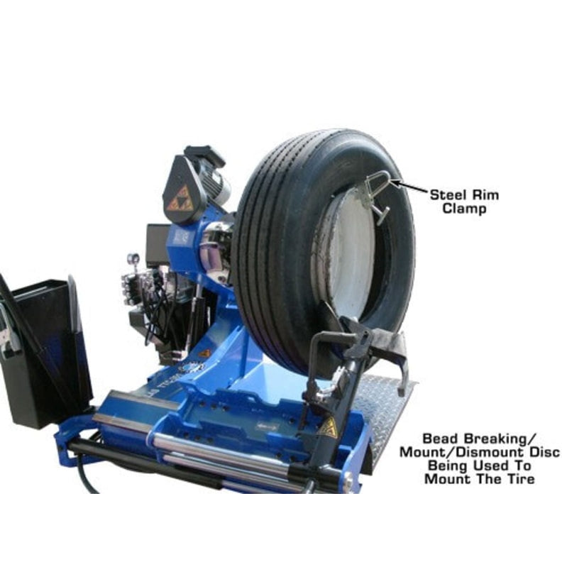 The Atlas TTC301 heavy-duty truck tire changer with a steel rim clamp being used to mount a tire and the bead breaking/mount/demount disc.