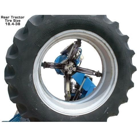 A close-up view of a large tire being mounted onto the four-jaw chuck of the Atlas TTC303 Super Duty Truck Tire Changer.