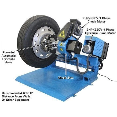 A detailed view of the Atlas TTC305A Automatic Truck Tire Changer, with labels pointing to the 3HP/220V/1 phase chuck motor and the 2HP/220V/1 phase hydraulic pump motor.