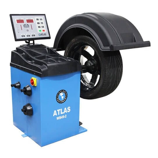 A front-view of the blue Atlas WB49-2 Wheel Balancer, with a mounted tire on a silver rim and a large, easy-to-read LED display with a diagram of the control panel.