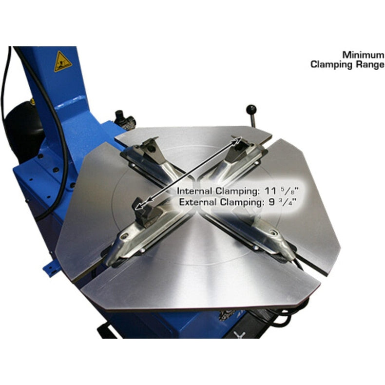 A close-up view of the turntable on the Atlas TC229LH Rim Clamp Tire Changer, showing the minimum clamping range with the jaws set for internal clamping at 11 5/8" and external clamping at 9 3/4".
