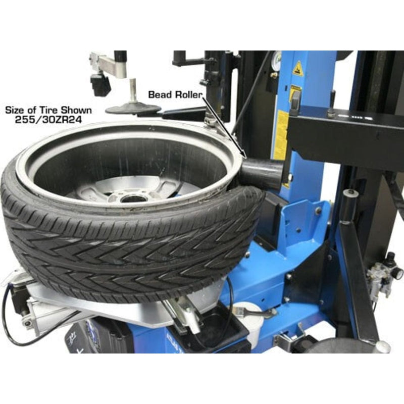 A tire mounted on the Atlas TC755DAA Tilt-Back Tire Changer. This close-up view shows the bead roller on the side and the mounted tire with a size of 255/30ZR24.