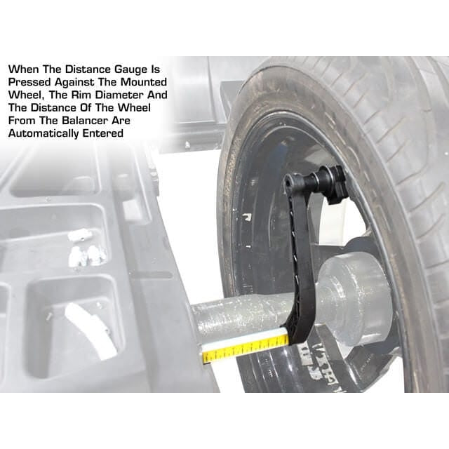 A close-up of the Atlas WB49-2 Wheel Balancer showing the distance gauge being used to automatically enter the wheel's distance, rim diameter, and rim width.