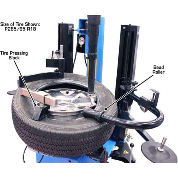 A tire mounted on the turntable of the Atlas TC289DAA tire changer, with annotations pointing out the Bead Pressing Block and Bead Roller, with the tire size P265/65 R18 visible.