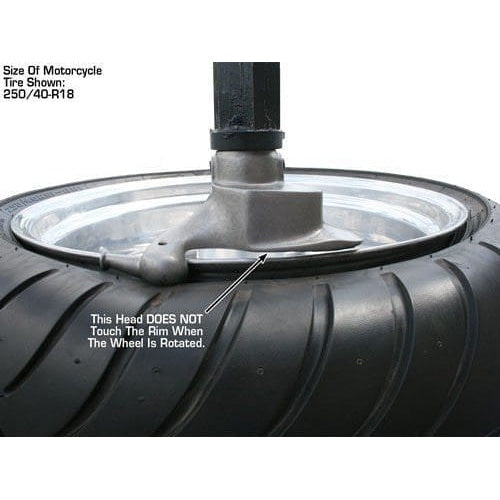 A close-up view of a tire being worked on by the Atlas TC289 Tire Changer, with an overlay text warning: "This head DOES NOT Touch The Rim When The Wheel Is Rotated".