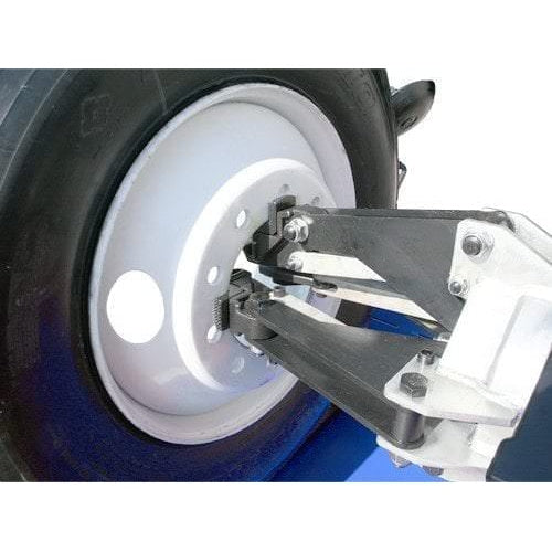 The Atlas TTC301's heavy-duty clamps securing a large wheel to the four-jaw chuck.