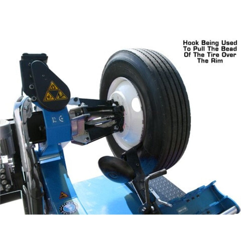 A demonstration of the Atlas TTC301's hook tool, with text overlay explaining it is used to pull the bead of the tire over the rim.