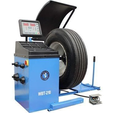 A front view of the Atlas WBT-210 Wheel Balancer with a large truck tire mounted on its shaft.