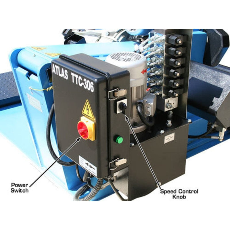 A close-up of the Atlas TTC306's control box, showing the red power switch and a speed control knob, with hydraulic lines and other components visible on the side.