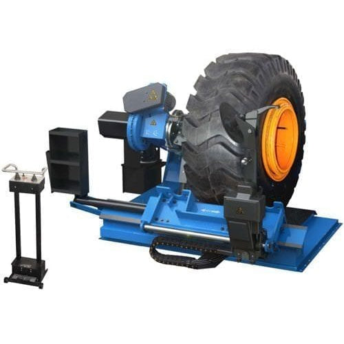 An Atlas TTC606 commercial truck tire changer, with a large tire mounted, placed next to a balancing machine. Both machines are blue and black, with yellow accents.