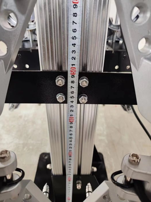 A close-up of the metal vertical pole of the Katool KT-AV6 3D Wheel Aligner, showing a black measurement tape with a ruler attached to it. The image highlights the detailed scale in both inches and centimeters, indicating the pole's full height adjustment capabilities.