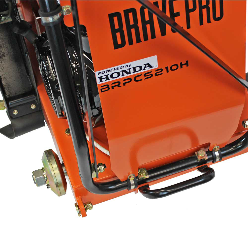 A close-up view of the Brave Pro 20-inch concrete floor saw's water valve and water tube connections near the blade on the orange frame.