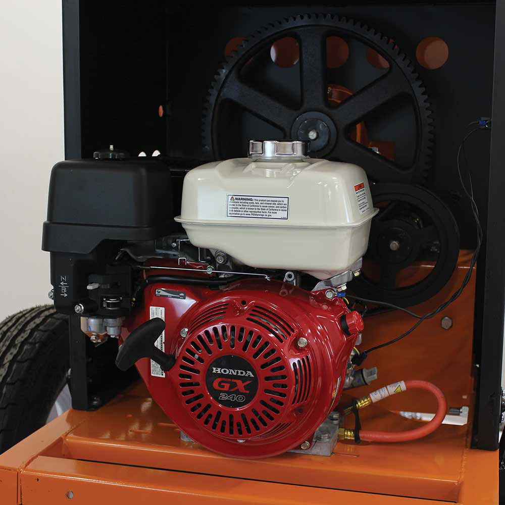 A close-up view of the red Honda GX engine and the large black gear on the Brave 8 Cu. Ft. Steel Drum Mortar Mixer.