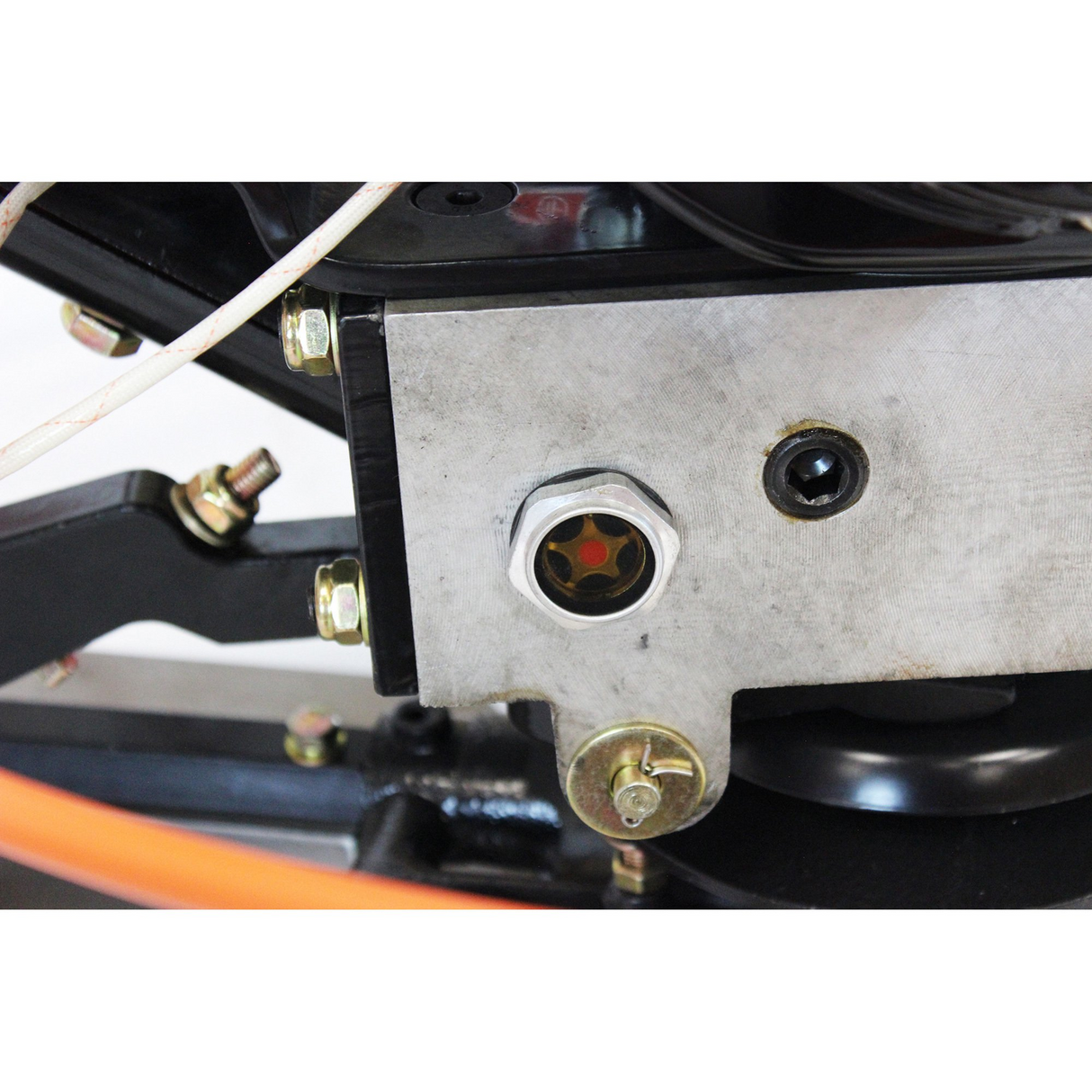 A close-up view of the gear box on the Brave 36-inch power trowel. The image shows the oil fill cap, a level sight glass with an orange star-like indicator, and the drain plug.