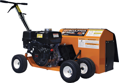 Three-quarter view of the Brave 9-in. Steerable Trencher/Bed Sculptor, showing its compact, steerable design with the engine and all four wheels visible. The product features several warning decals.