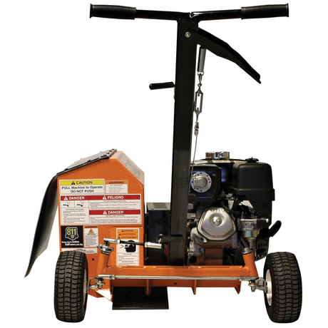 Front view of the orange and black Brave 9-in. Steerable Trencher/Bed Sculptor, showing the engine, wheels, and dual-handlebar steering. The product has a "DANGER" warning decal.
