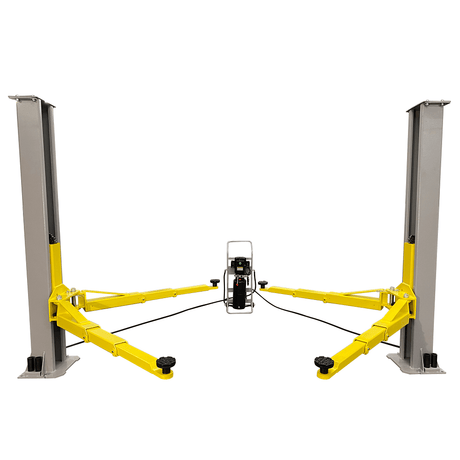 A front view of the Triumph C-7000 Portable Two-Post Car Lift in a light grey and yellow color scheme with a lifting capacity of 7,000 lbs. The lift is fully assembled with the hydraulic power unit positioned in the middle, and the yellow lift arms extended outwards.