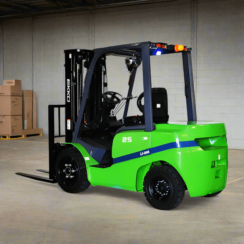 A green EKKO EK25GT Wheel Electric with solid pneumatic tires in a warehouse setting with stacks of boxed products in the background.