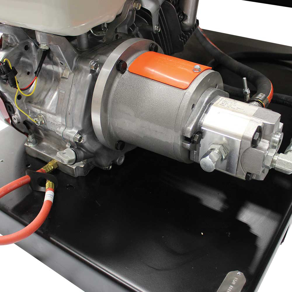 A detailed close-up of the hydraulic pump connected to the Honda GX engine on the Brave hydraulic power pack, showing the pump's silver and orange housing.