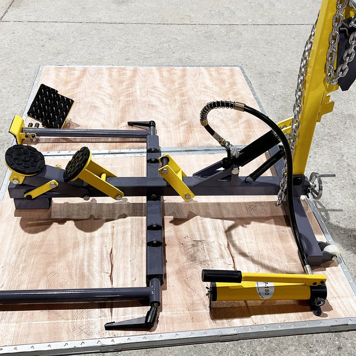 A dismantled Katool KT-222 Quick Sheet Metal Repair Device on a wooden pallet, with all of its black and yellow components and accessories laid out, including the hand pump and multiple pulling attachments.