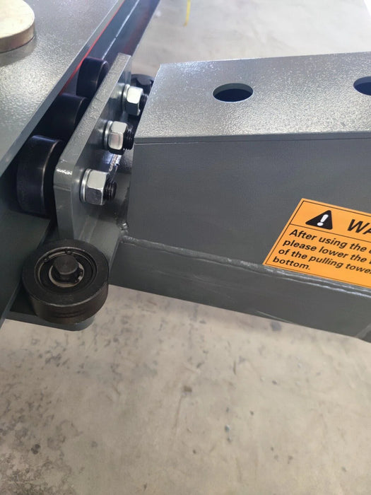 A close-up of the Katool KT-299U frame, showing the wheel support and a yellow warning sticker. A measuring tape is visible, referencing the precise dimensions of the frame.