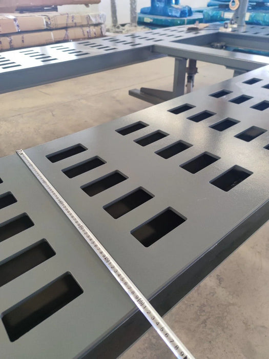 A detailed close-up of the Katool KT-299U frame, showing the precise square holes and a measuring ruler laid across the surface, emphasizing the machine's structural integrity and accurate design.