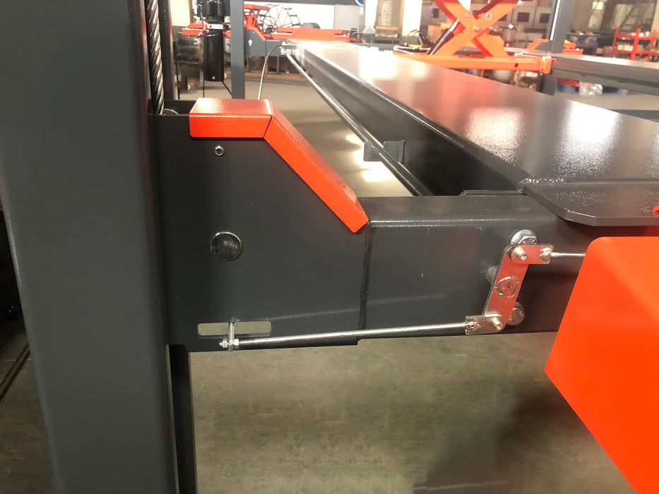 A wide-angle shot of the gray Katool KT-4H110 4-post car lift with orange ramps, set up in a garage or workshop with the main door open in the background. The image highlights the full length of the runways and the lift's overall footprint