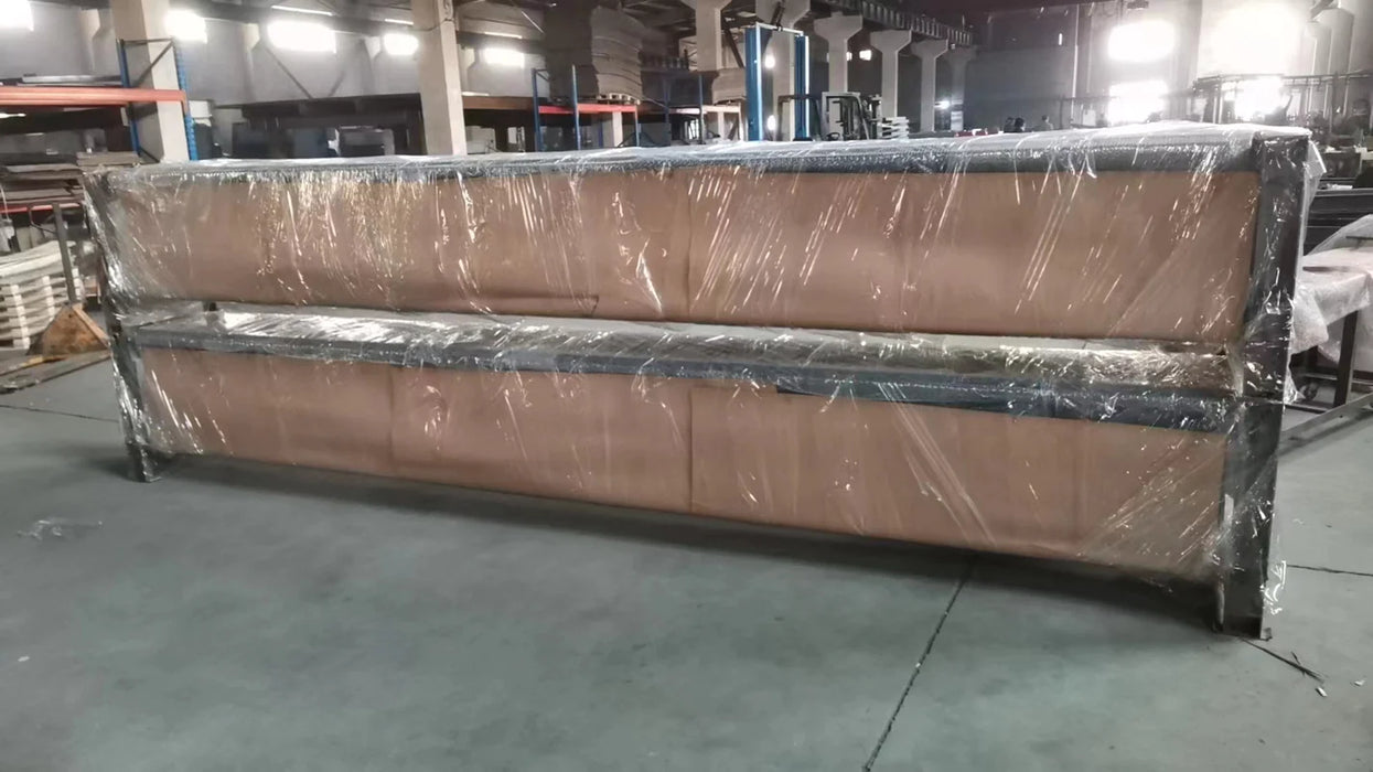 An image of the Katool 4-post KT-4H110 vehicle lift's runways, shown wrapped in protective brown paper and clear plastic, ready for shipment in a warehouse setting