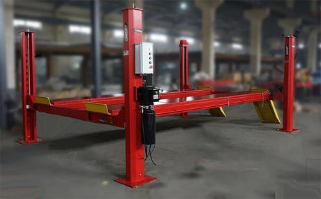 A full view of the Katool KT-4H150 4-post lift inside a workshop, highlighting its durable steel structure and runway design.