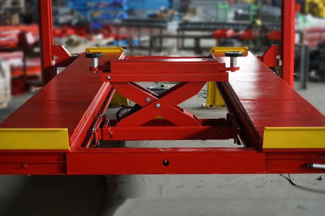 A close-up view of the red and yellow runways on the Katool KT-4H150 4-post lift, featuring the rolling jack with its scissor-style lifting mechanism.