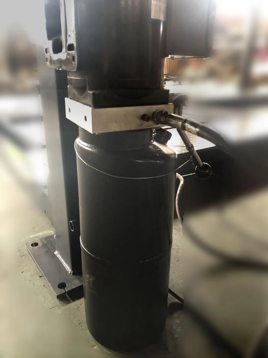 A detailed view of the hydraulic cylinder on the car lift's main post