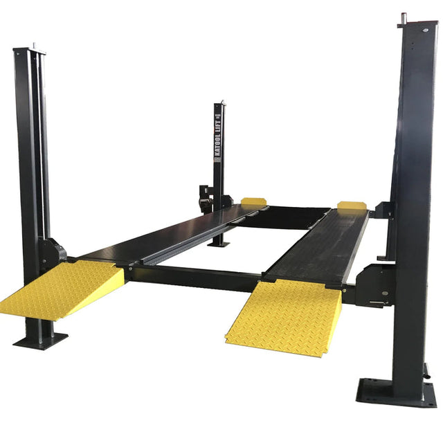A large, black and yellow Katool 4-post car lift with an 8,500 lbs lifting capacity