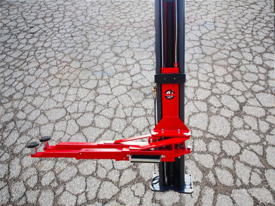 A detailed close-up of the red hydraulic lifting arm on the black post of the Katool KT-AS110D 2-post car lift, highlighting the hydraulic cylinder and its robust construction
