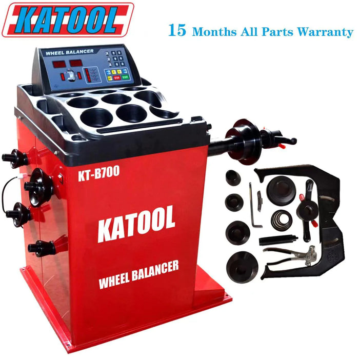 Red KATOOL KT-B700 wheel balancer machine with digital display, labeled "WHEEL BALANCER." Various tool parts and accessories are shown next to the machine. Text states a 15-month warranty.