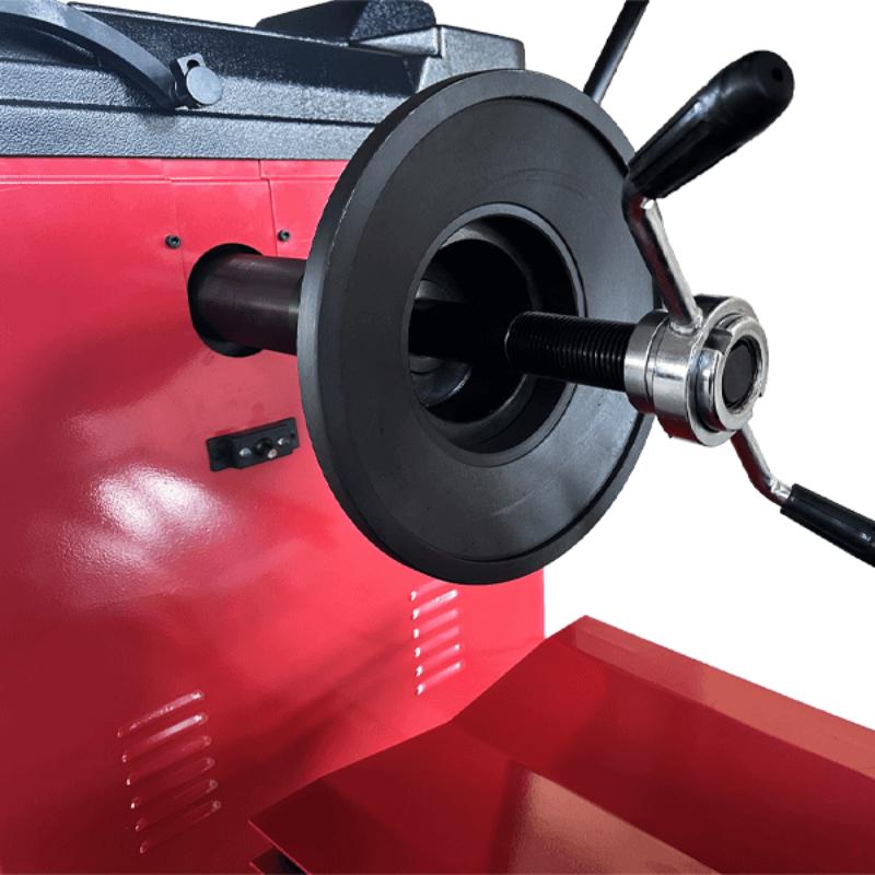 A side view of the quick-release hub on the Katool KT-B795L Heavy Duty Truck Wheel Balancer, revealing the threaded shaft and ergonomic handle that facilitates quick and easy wheel installation.