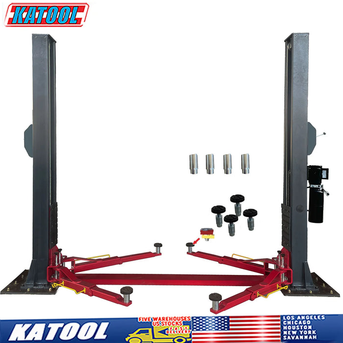 A product shot of the Katool H120D 12,000 lb. Two Post Lift, with its key accessories displayed in front. The image highlights the rubber pad door protectors, screw-on pads, and extension support adapters. The base plate configuration and the sturdy columns are also clearly visible.