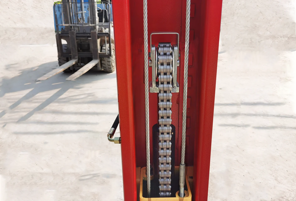 A view of the dual hydraulic chain-drive system within the red column of the Katool KT-M110 2-post lift, with a forklift visible in the background.