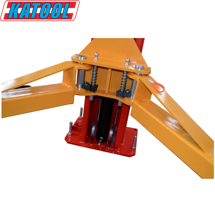 A detailed view of the yellow lift arm and red carriage on the Katool KT-M110 lift, highlighting the double hydraulic cylinders and chain drive.