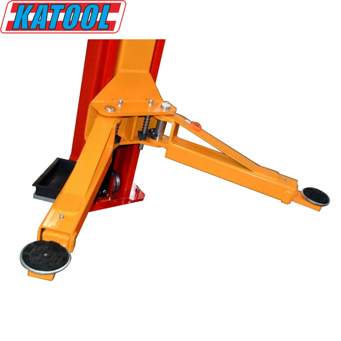 A close-up of the adjustable yellow lift arm and black rubber pad on the red Katool KT-M110 2-post car lift.