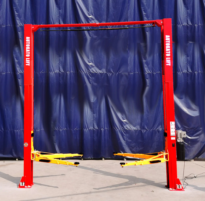 A full, wide shot of the red Katool KT-M120 2-Post Car Lift with its yellow lifting arms, placed in a workshop with a blue background, showcasing the full structure of the lift.