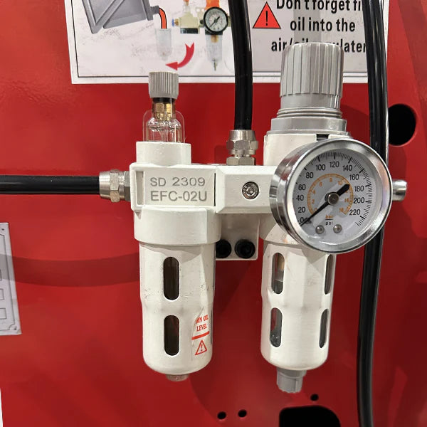 A close-up of the pressure gauge and filter components on the side of the Katool KT-T830 tire changer. Text warns to add oil to the air filter regularly.