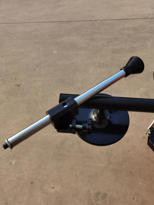 A close-up shot of the bead seater arm on the Katool KT-T835 tire changer. The black and silver arm is positioned to show how it would be used to seat a tire bead on the wheel.