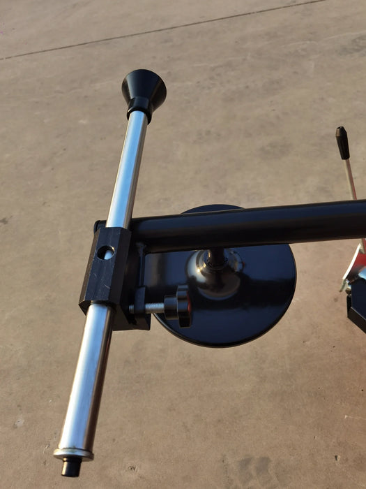 A close-up view of the Katool KT-T835 tire changer's assist arm and bead seater. The silver and black components highlight the machine’s heavy-duty construction and the purpose of the assist arm.