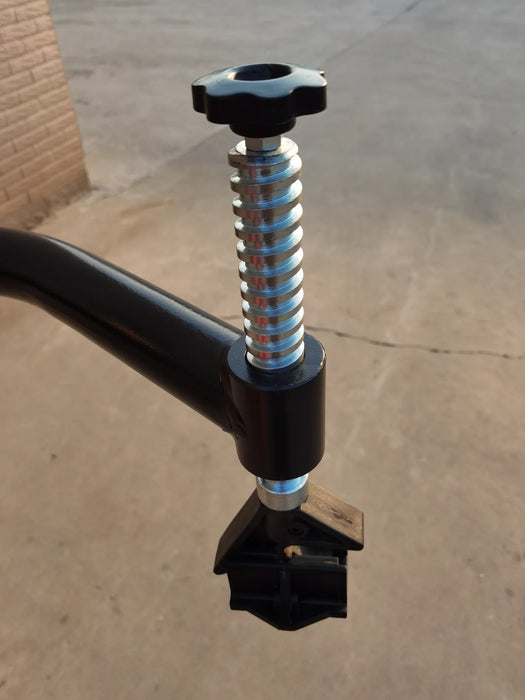 A detailed, close-up shot of the spring and knob on the Katool KT-T835 tire changer's assist arm, highlighting the mechanism for controlling the arm's tension and position.