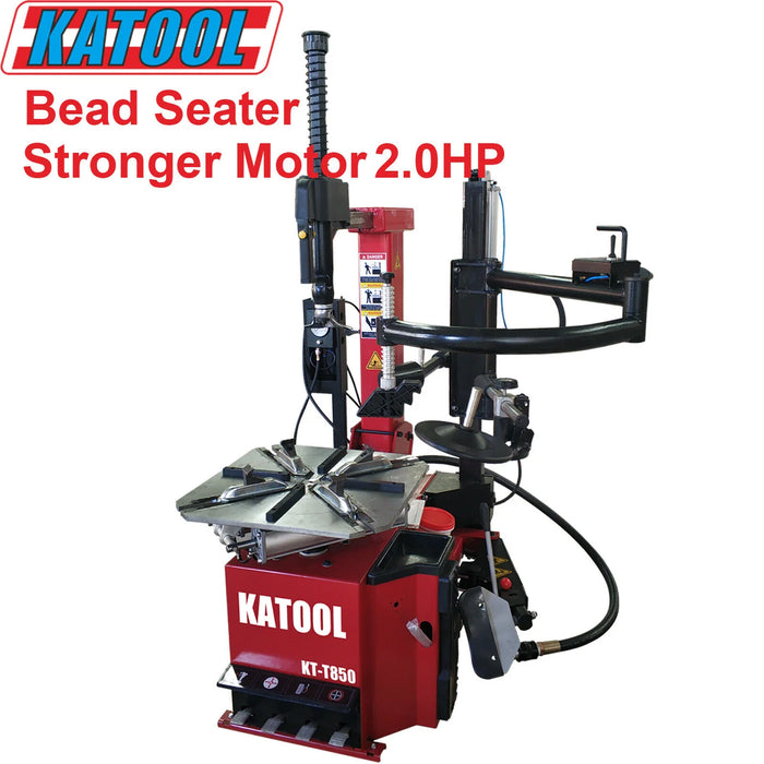 A red Katool KT-T850 tire changer featuring a 2.0HP motor and an integrated bead seater. The machine is shown with its professional-grade components including the assist arm and turntable.