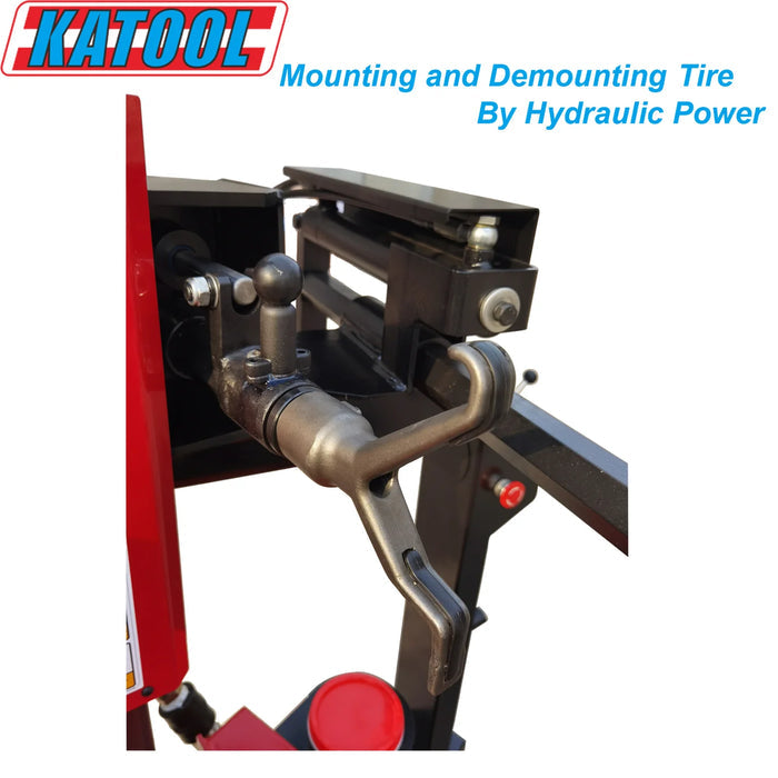 A close-up view of the hydraulic power-operated mounting and demounting arm on the Katool KT-T900 tire changer. The text overlay reads, "Mounting and Demounting Tire By Hydraulic Power".