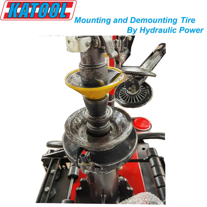 A top-down, close-up view of the center mounting hub and hydraulic arm of the Katool KT-T900 tire changer. The image highlights the powerful hydraulic system designed for mounting and demounting tires.