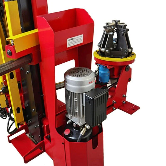 A close-up side view of the hydraulic motor on the red and yellow Katool KT-TV910 truck tire changer. This angle highlights the robust build and the machine’s powerful components.