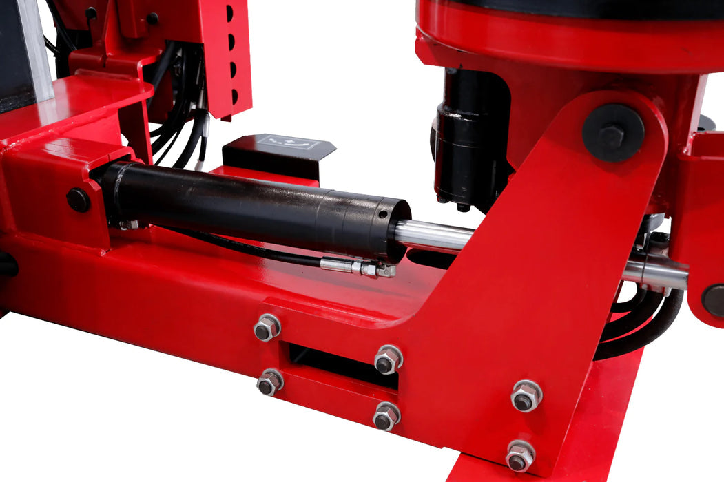 A detailed, close-up shot of the hydraulic cylinder on the red Katool KT-TV910 truck tire changer. The image emphasizes the powerful hydraulic mechanism responsible for heavy-duty lifting and clamping.